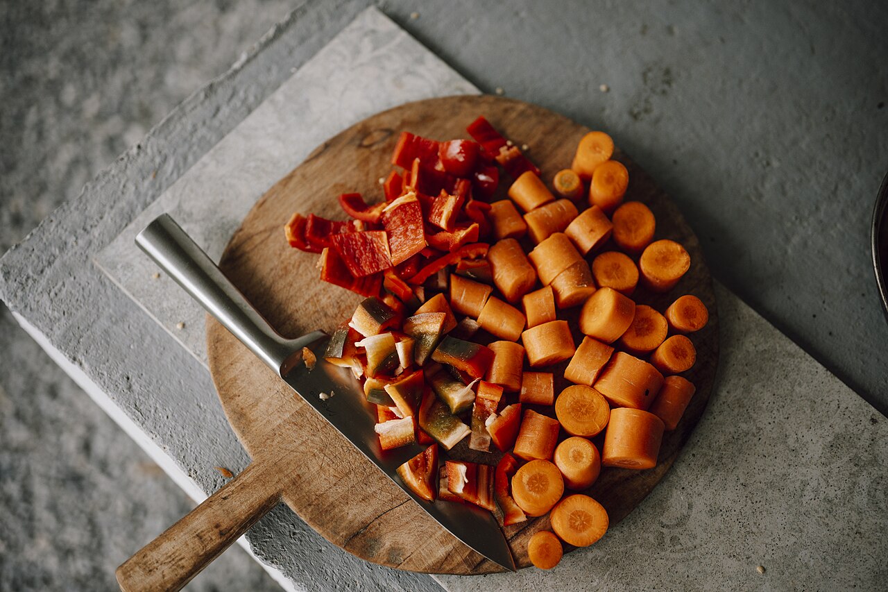 Freshly chopped vegetables on a wooden cutting board